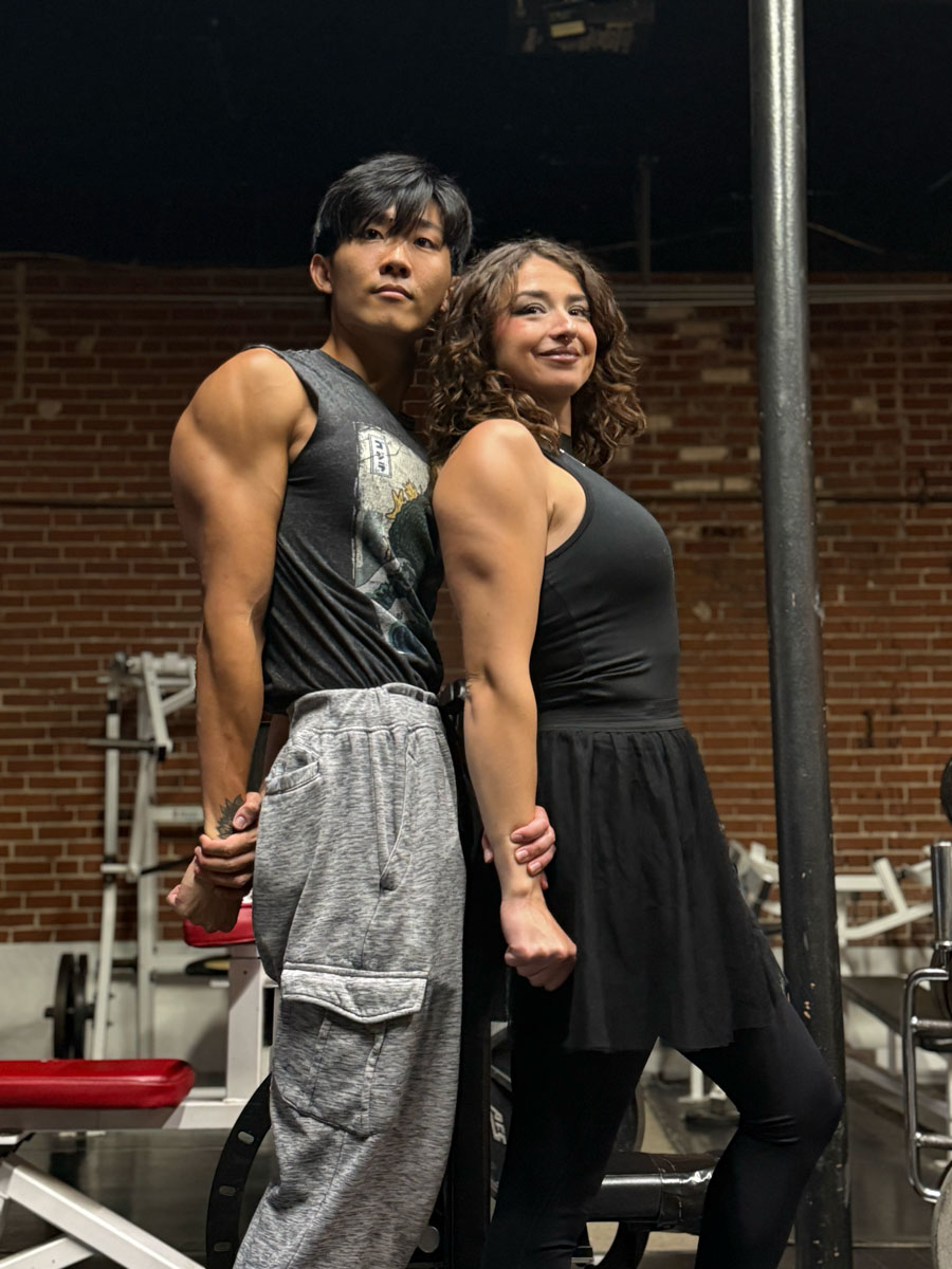 Coaches holding dumbbells and laughing